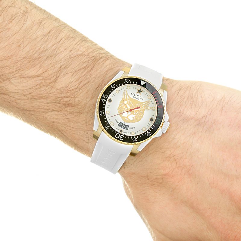 Brand: Gucci Series: Dive Model: YA136322 Gender: Men's Movement: Quartz Water Resistance: 200 meters / 660 feet Features: Analog, Ceramic, Gold, Rubber, Stainless Steel