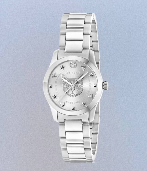 Silver Gucci watch on a light blue background